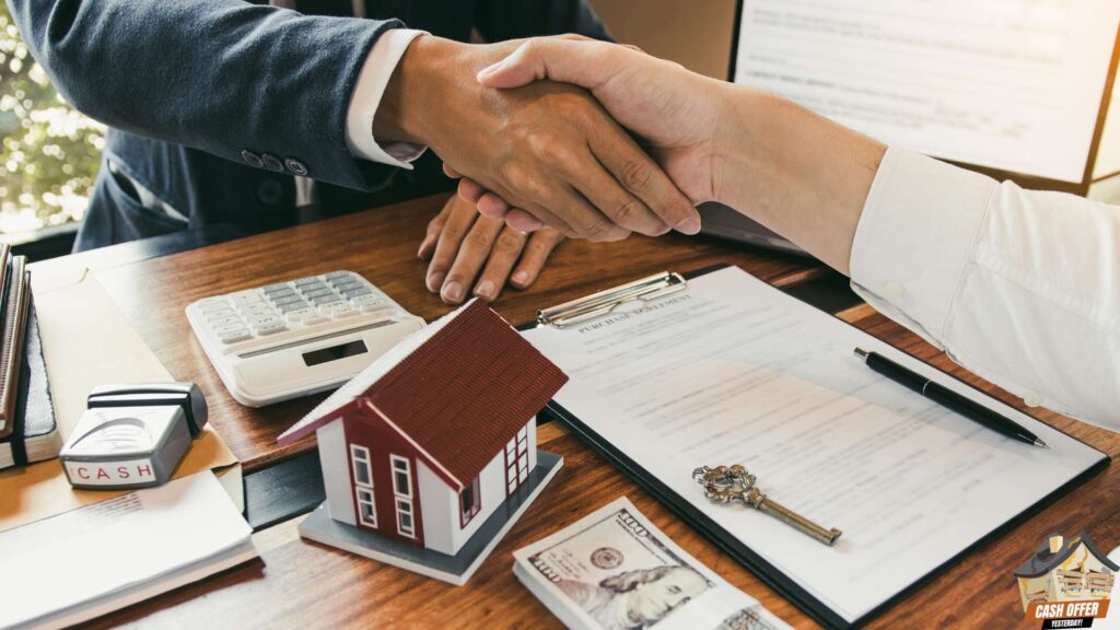 Buyer and seller shaking hands with a miniature house, contract, key, and money on the table, We Buy Houses in Benbrook TX